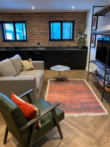 a living room with a couch and a chair at Country Apartment in Hurstpierpoint