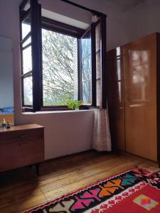 a room with a large window and a rug at Leppo Guest House in Gacko