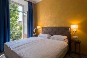 a bedroom with a large bed and a window at Hotel Zurigo Downtown in Lugano