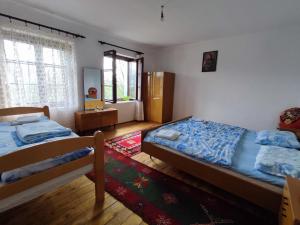 a bedroom with two beds and a window at Leppo Guest House in Gacko