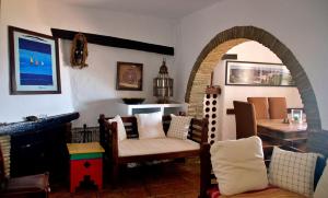a living room with a chair and a table at Casa Muryo in Jimena de la Frontera