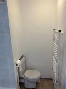 a bathroom with a toilet and a toilet paper dispenser at Combettes Studio Apartment in Les Contamines-Montjoie