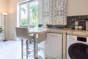 a kitchen with a counter and a dishwasher at Our boutique Fort Lauderdale guest house in Fort Lauderdale