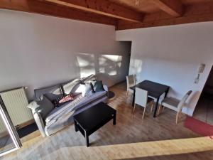 a living room with a couch and a table at Kuschelige Maisonette in Lannach +9 photos