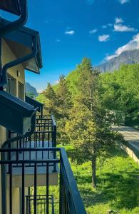 a view from the balcony of a house with a tree at Hotel Gold Kazbegi in Kazbegi