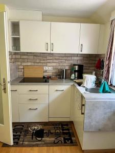 a kitchen with white cabinets and a counter top at Felsenblick Himmelsfels in Geislingen an der Steige