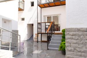 a hallway of a house with stairs and a stair railing at Cozy apartment with balcony in Bodrum City