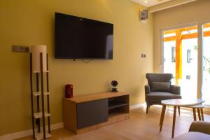 a living room with a flat screen tv on the wall at Cozy apartment with balcony in Bodrum City