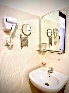 a bathroom with a sink and a mirror at Lovely Studio Condominiums at Mesavirre Garden Residences Bacolod in Bacolod