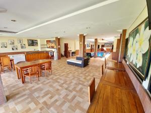 a living room with a table and chairs and a dining room at Caroline Guest House in Canggu