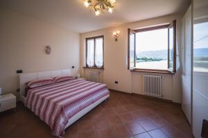 a bedroom with a bed and a large window at Casa Gori in Lucca