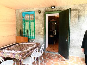 a table and chairs on the porch of a house at Dabakhnebi in Telavi