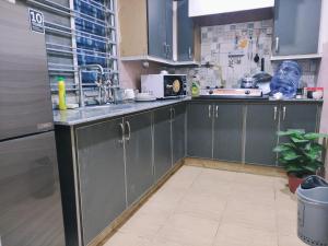 a kitchen with stainless steel cabinets and a sink at QB Elegant Villa Bahria Town in Rawalpindi