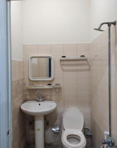 a small bathroom with a toilet and a sink at QB Elegant Villa Bahria Town in Rawalpindi