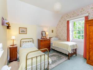 a bedroom with two beds and a window at The Ivy Wing in Slickly