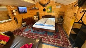 a bedroom with a bed in a wooden room at Oase im Moor in Quickborn