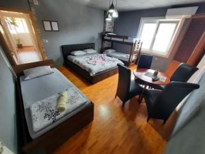 a bedroom with a bed and a table and chairs at Apartment Jonoski in Ohrid