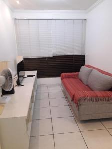 a living room with a couch and a desk at Kit no Lago Norte CA 02 in Brasilia