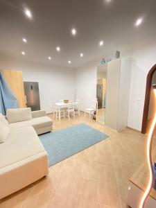 a living room with a couch and a table at Marechiaro Apartments in Palermo