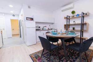 a kitchen with a table and chairs in a room at O&O Group - The SeaGate Estate suites - Suite 1 in Rishon LeẔiyyon