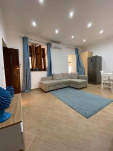 a living room with a couch and a blue rug at Marechiaro Apartments in Palermo