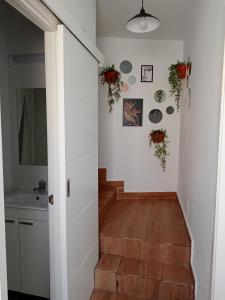 a staircase in a house with a white wall at A casiña de Vilaxoan in Vilagarcia de Arousa