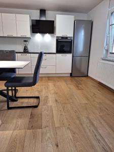 a kitchen with a table and a refrigerator at Guesthouse Flower in Ljubljana