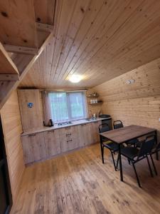 a room with a table and chairs in a cabin at Pine Chalet Kazbegi in Kazbegi