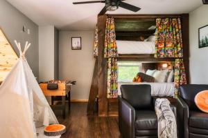a bedroom with two bunk beds and a desk at Mountainside - New Luxury Cabin-Fire Table-Hot Tub-3 Pools-PS5-Bears in Gatlinburg