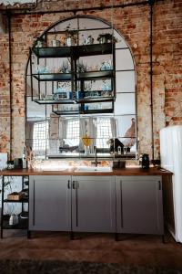 a kitchen with a sink and a brick wall at design LOFT 22 in Warsaw