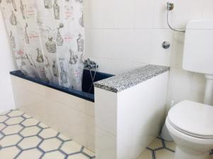 a bathroom with a toilet and a shower curtain at Villa Ida in Capo Rizzuto +93 photos