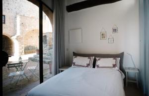 a bedroom with a bed and a large window at canonica 43 in Colle di Val d'Elsa