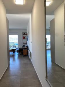 a hallway with a mirror and a living room at Apartment Primero in Primošten