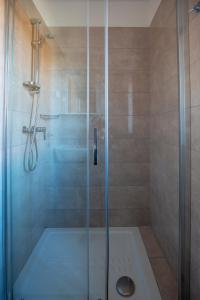 ein Bad mit einer Dusche und einer Glastür in der Unterkunft Apartments and Rooms Ješelnik in Portorož