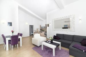 a living room with a couch and a table at Apartment Perla in Dinjiška