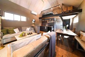 a living room with a couch and a loft at Villa Nyman in Pietarsaari