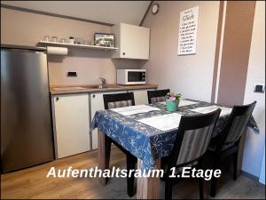 a small kitchen with a table and a refrigerator at Bed & Breakfast Pension in Legden +31 photos