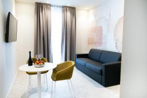 a living room with a couch and a table at Hotel Cristallo in Senigallia