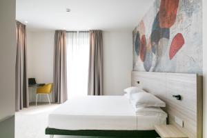 Postel nebo postele na pokoji v ubytování Hotel Cristallo