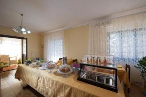 a dining room with a table with a tableablish at La Rosa dei Venti B&B in Chia