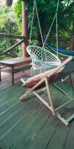 Una silla colgante en una terraza con un banco en OAZA, en Olsztyn