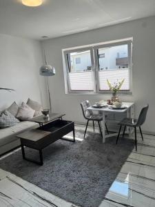 a living room with a couch and a table and chairs at Feel like Home 1 in Biberach an der Riß