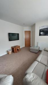 a living room with a couch and a flat screen tv at Strathalban cottage in Aberlour