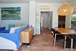 a living room with a blue couch and a table at Villa Torrent Costa Brava, con piscina privada! in Pals +52 photos