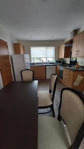 a kitchen with a table and chairs in a room at Strathalban cottage in Aberlour