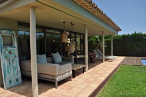 a pavilion with a couch and chairs on a patio at Villa Torrent Costa Brava, con piscina privada! in Pals