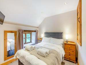 a bedroom with a large bed with two towels on it at The Cider House in Clee Saint Margaret