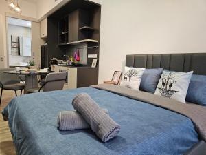 Millerz Square OKR - Suites & Residences 객실 침대