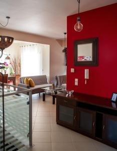 a living room with a red wall at Holiday Lefkas Moonlight Luxury Appartments in Nikiana