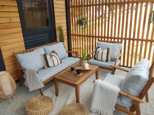 a porch with two chairs and a couch and a table at Mobile homes PIA RITA in Pakoštane
